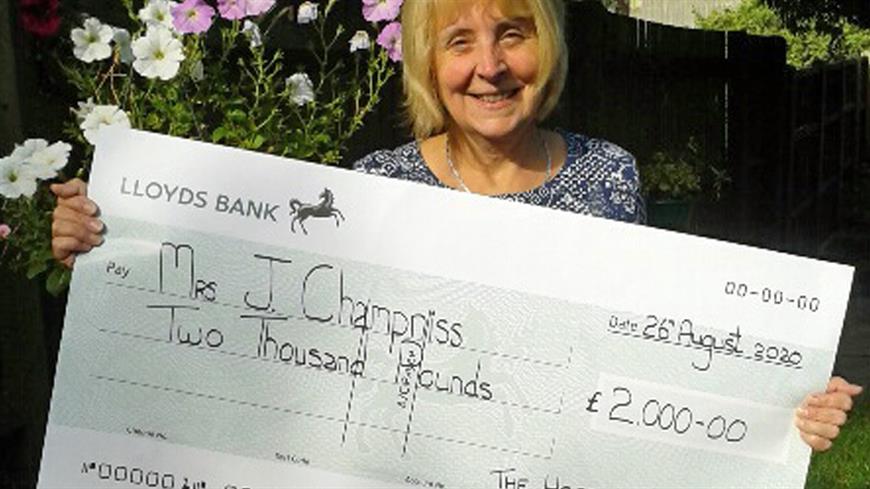 Summer Superdraw Winner receiving cheque